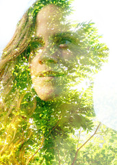 Wall Mural - Double exposure close up of a young happy natural beauty and bright shining tropical leaves