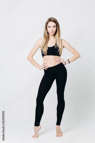Sporty Blonde Woman Wearing In Black Wear Posing At Studio