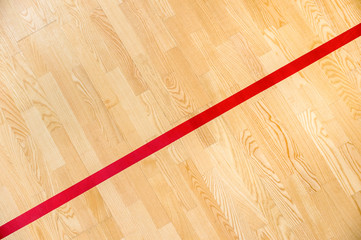 Red line on the gymnasium floor for assign sports court. Badminton, Futsal, Volleyball and Basketball court