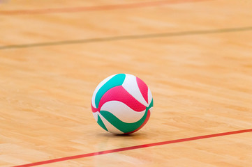 Volleyball court wooden floor with ball isolated on black with copy-space