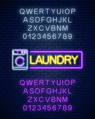 Wall Mural - Glowing neon laundry signboard with alphabet. Illuminated self-service washhouse sign working round-the-clock.