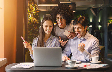 Poster - Successful business team looking at laptop happily