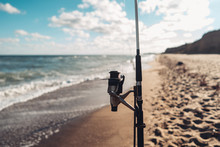 Several Fishing Rods In A Row On The Beach