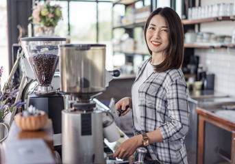 Sticker - woman preparing coffee with machine in cafe