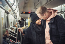 Happy Young Tourist Couple In New York City Subway Train Travel Around