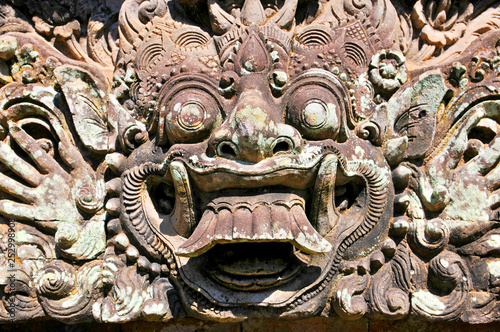 Fotomural Carvings depicting demons, gods and Balinese mythological deities can be found throughout the Pura Dalem Agung Padangtegal temple in the Monkey Forest Sanctuary in Ubud, Bali, Indonesia