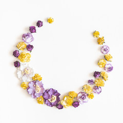 Flowers composition. Wreath made of purple and yellow flowers on white background. Flat lay, top view, copy space, square