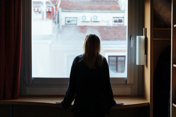 Woman looking through the window