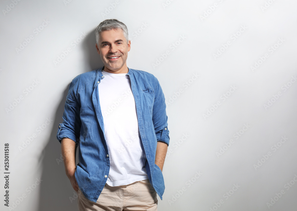 Portrait of mature man on grey background