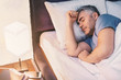 © Pixel-Shot - Mature man sleeping in bed at home