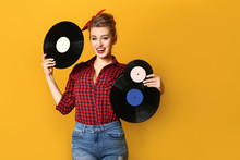 Beautiful Pin-up Woman With Vinyl Discs On Color Background