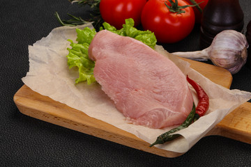 Raw Turkey steak served rosemary