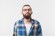 © satura_ - Beauty, fashion and people concept - Portrait of a young bearded hipster stylish guy over white background.