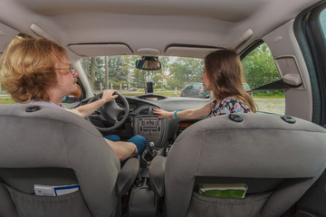 Couple in car setting air conditioning