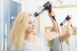 © anetlanda - Blonde woman using hair dryer