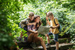 © BalanceFormCreative - Mother and her little sons hiking .They taking a break and sitting on the old stairs.Examining map.