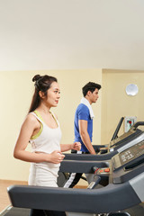 Couple exercising on treadmills