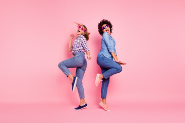 Full length body size profile side view portrait of two person nice crazy carefree attractive charming playful cheery girls in casual checkered shirt having fun isolated over pink pastel background