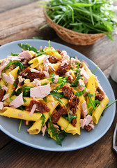 Wall Mural - Penne pasta with tuna chunks, rucola and dry tomatoes