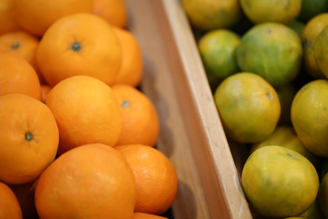 Wall Mural - Close up view of orange fruits on the shelf in the supermarket