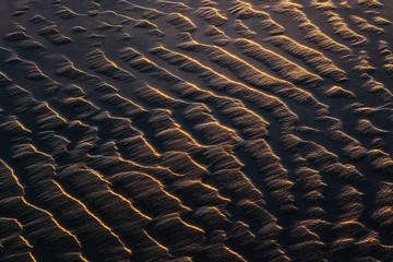 Poster - sand waves textures and puddles on beach shore at sunset