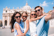 © travnikovstudio - Happy family taking selfie in Vatican city and St. Peter's Basilica church, Rome, Italy