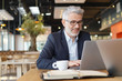© goodluz - Smiling businessman in informal meeting