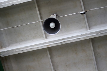 Grunge lamp on the concrete ceiling of the industrial warehouse of the manufactory plant bottom view