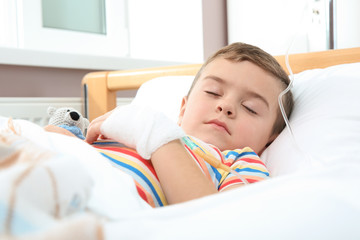 Wall Mural - Little child with intravenous drip sleeping in hospital bed