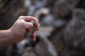 stone in man's hand