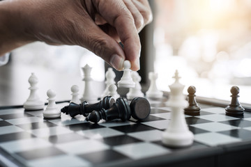 Wall Mural - Hands of confident businessman colleagues playing chess game to development analysis new strategy plan, leader and teamwork concept for win and success