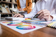 © Freedomz - Two colleagues creative graphic designer working on color selection and drawing on graphics tablet at workplace