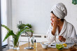 © lordn - Young woman cleaning face with natural cosmetics. Clean fresh skin care.