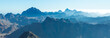 © Mountains Hunter - Beautiful view from the mountain. Panorama. Mountain range with visible silhouettes through the morning blue fog.