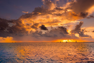 Wall Mural - dramatic sunset taken from mallory square in key west florida capturing a sunset sail.
