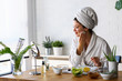 © lordn - Young woman cleaning face with natural cosmetics. Clean fresh skin care.