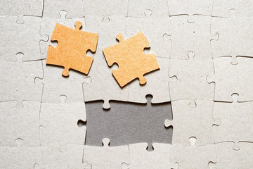 Puzzle pieces on a gray surface, closeup, top view