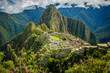 Famous view of Machu Picchu city in pink flowers, Peru