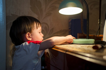 little kid turning off the light