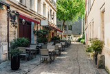 Fototapeta Uliczki - Cozy street with tables of restaurant in Rouen, Normandy, France