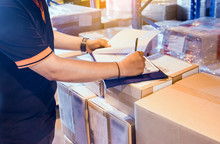 Warehouse Worker Writing On Clipboard His Checking Details The Shipments Boxes. Commerce Supply Chain. Cargo Shipping. Warehouse Inventory Managemant.
