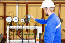 Technician Inspector On Refinery Plant Checking Pressure Gauges