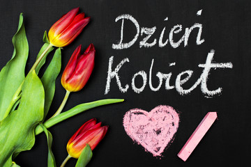 Women's Day card and a bouquet of beautiful tulips on blackboard background, with Polish words 