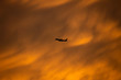 © next143 - A yellow turbulence cloud with silhouette airplane flying through