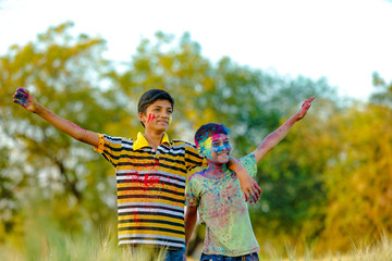 Indian child playing with the color in holi festival