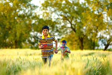 Indian child playing with the color in holi festival