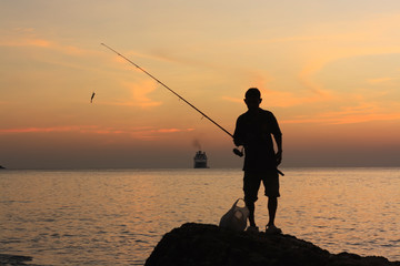 fishing at sunset