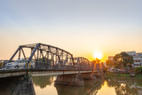 Fototapeta Most - Iron bridge in Chiangmai during sunset time with beautiful lens flare.