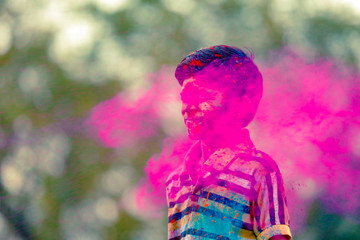 Indian child playing with the color in holi festival