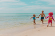 © nadezhda1906 - happy kids run on beach, boy and girl play with water